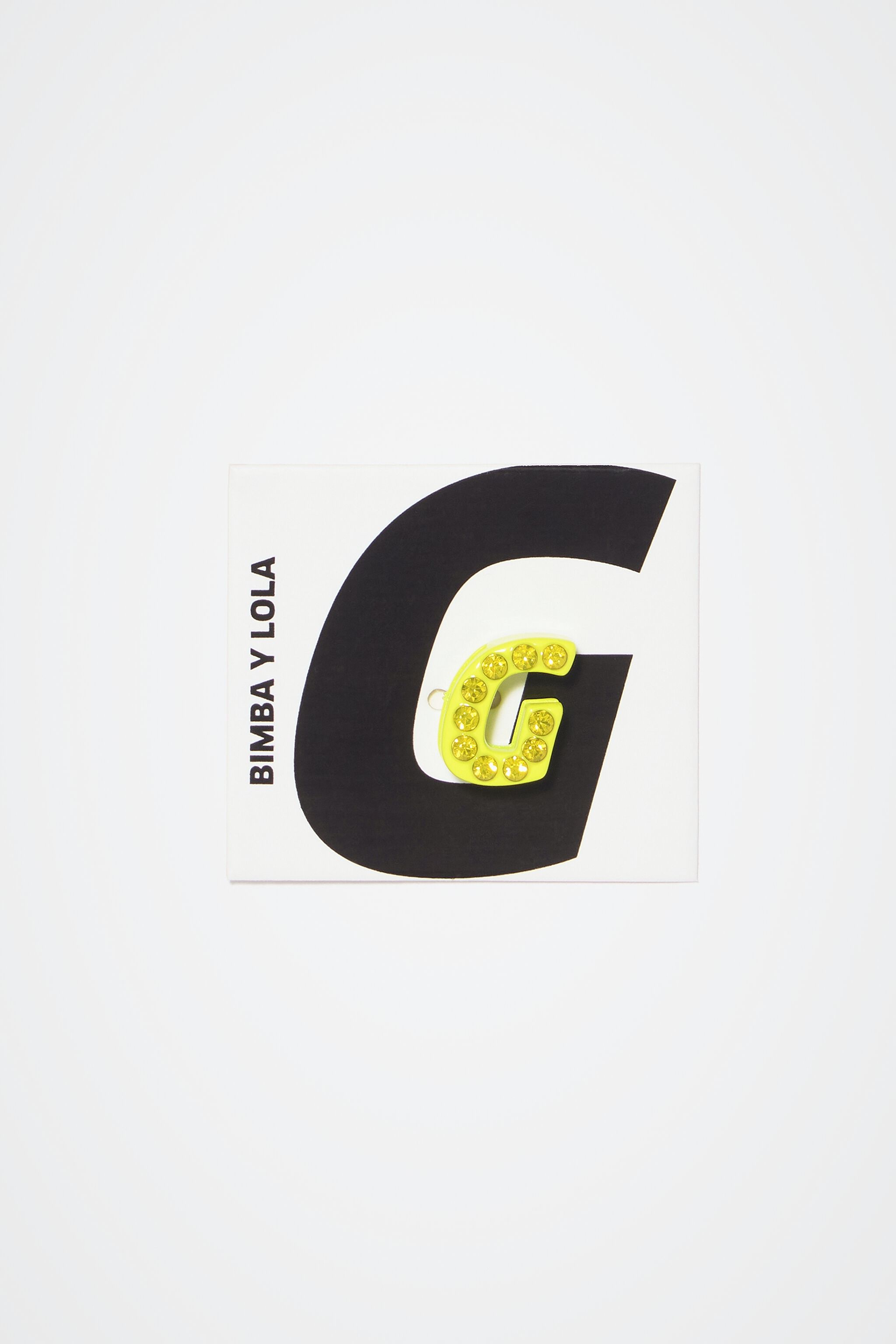 Neon yellow letter G metal charm