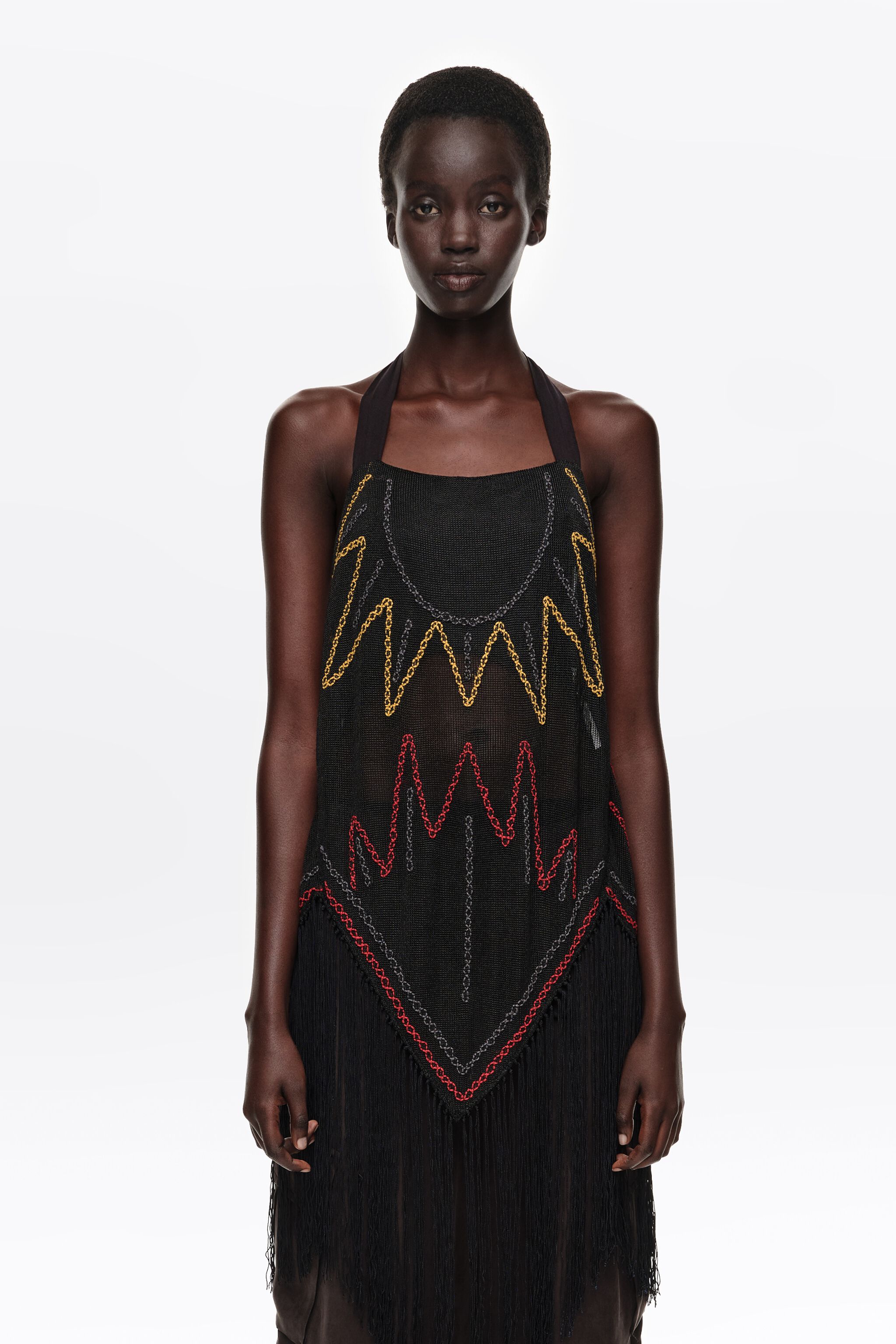 Black embroidered knit top with fringing