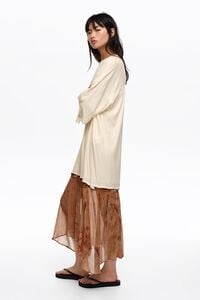 Tweekleurige jurk voor onder water met knoopjes aan de zoom.