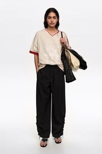 Ivory V-neckline Dancers logo T-shirt