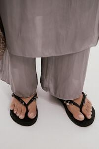Black flip-flop with piercings