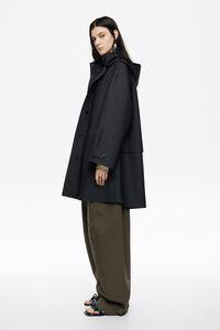 Dark blue rubberized A-line trench